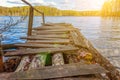 Forest lake or river on summer day and old rustic wooden dock or pier Royalty Free Stock Photo