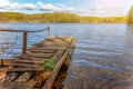 Forest lake or river on summer day and old rustic wooden dock or pier Royalty Free Stock Photo