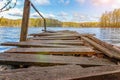 Forest lake or river on summer day and old rustic wooden dock or pier Royalty Free Stock Photo