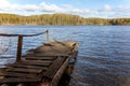 Forest lake or river on summer day and old rustic wooden dock or pier Royalty Free Stock Photo