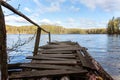 Forest lake or river on summer day and old rustic wooden dock or pier Royalty Free Stock Photo