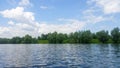 Forest lake under blue cloudy sky Royalty Free Stock Photo
