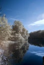 Infrared lake landscape in blue tones Royalty Free Stock Photo