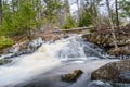 Forest landscape with small river cascade falls over mossy rocks Royalty Free Stock Photo