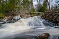 Forest landscape with small river cascade falls over mossy rocks Royalty Free Stock Photo