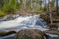 Forest landscape with small river cascade falls over mossy rocks Royalty Free Stock Photo