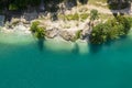 Forest and limestone quarry lake shore. coastline aerial view