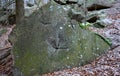 Forest mining of granite stone directly in the forest on solitary boulder. In the past, the easiest way to get a stone. to this da