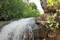 Forest mountain waterfall in summer. Bottom view