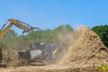 Forest mulcher is loaded with roots trees to be chopped by an industrial shredder a machine Royalty Free Stock Photo