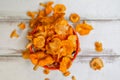 Forest Orange mushrooms chanterelles in a wicker basket and scattering on a white wooden table. Close up. View from the top. Royalty Free Stock Photo