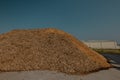 Forest residues mulched as wood chips used for heating. Pile of wood chip particles for biomass boiler, view from below