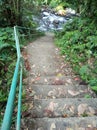 Forest river stairs in perspective. Outdoor stairs with iron fence and autumn leaves background. Stairs to climb around nature