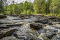 The water rolls down very quickly and noisily over flat stones.