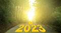 Word 2023 written on forested rural road