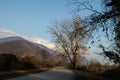 Forest Road Under Sunset Sunbeams. Beautiful sunset with orange and red clouds behind some coniferous trees. Azerbaijan, Caucasus Royalty Free Stock Photo