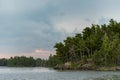 Forest and Rocks At The Edge of Rainy Lake Royalty Free Stock Photo