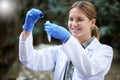 Forest, sample and woman scientist examine water for research or inspection of the ecosystem and environment study