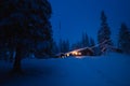 Forest scandinavian cabin in snowy woodland. Winter in Norway