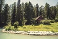 Forest and small house in it in summer day. Wooden two-storey cottage. Cabin in the woods. The tourist base for a stay in the fore Royalty Free Stock Photo