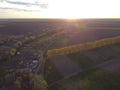 Forest strip between fields and small plots with crops in the ravine, evening above the village Royalty Free Stock Photo