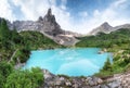 Forest and turquoise lake in the Dolomites apls, Italy.