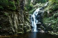 Forest waterfall. Water flowing from the stone mountain. Royalty Free Stock Photo