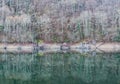 Forest in winter reflected in the river