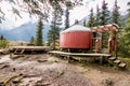 Forest Yurt Against Trees and Mountain Backdrop