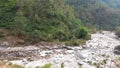 Forested hills of the asian mountains and strem of water.