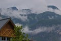 Forested mountain slopes and mountain ridges with silhouettes of evergreen coniferous trees shrouded in clouds and fog. Royalty Free Stock Photo