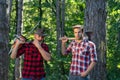 Foresters men. Man with serious face carries axe. Lumberjack brutal holds axe. Brutal lumberjack concept.