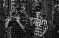 Foresters men. Man with serious face carries axe. Lumberjack brutal holds axe. Brutal lumberjack concept. Royalty Free Stock Photo