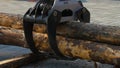 A forestry machine loads a log truck at the site landing. Forest machine down logs Royalty Free Stock Photo