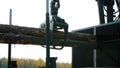 A forestry machine loads a log truck at the site landing. Forest machine down logs Royalty Free Stock Photo