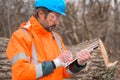 Forestry technician collecting data notes in forest