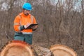 Forestry technician collecting data notes in forest