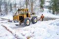 forestry tractor and anonymous woodcutters during the export of wooden logs from the fores