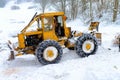 forestry tractor and anonymous woodcutters during the export of wooden logs from the fores