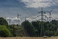 Forests and blue sky wih clouds and windy power plants and electric poles