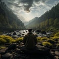 At forests edge, man seated facing outward, offering back view perspective