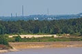 Forests on the shore of a lake in Hoge Kempen, with industrial buildings and chimneys in the backgroundndmill