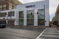 A Forever 21 store with a truck driving on the street, traffic signals, a red brick sidewalk, red brick buildings on a cloudy day