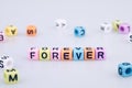 Forever word text written on colorful cube with bokeh cube word Royalty Free Stock Photo