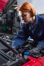 forewoman in uniform fixing motor of