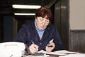 Forewoman writing at the desk