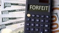FORFEIT - word written on a calculator on the background of banknotes Royalty Free Stock Photo