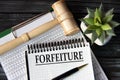 FORFEITURE - word on a white sheet on the background of a judge\'s gavel, a cactus and a pen