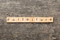 forfeiture word written on wood block. forfeiture text on table, concept