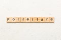 forfeiture word written on wood block. forfeiture text on table, concept